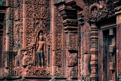 棕色混凝土建筑上的男性雕像
